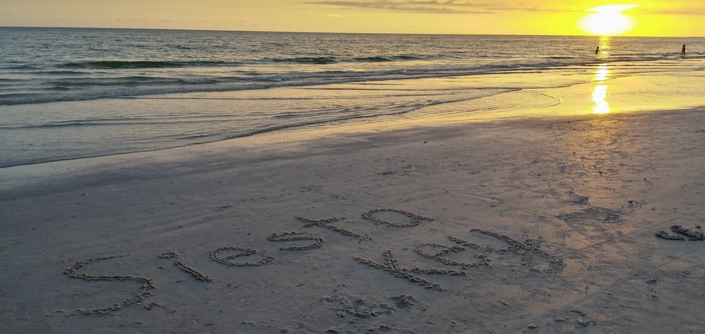 photo of the words Siesta Key written in the sand on Siesta Key
