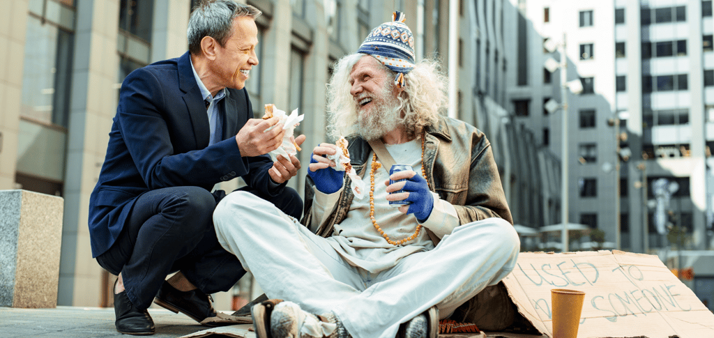 a man sitting on the ground with a sign that says,'i am sorry
