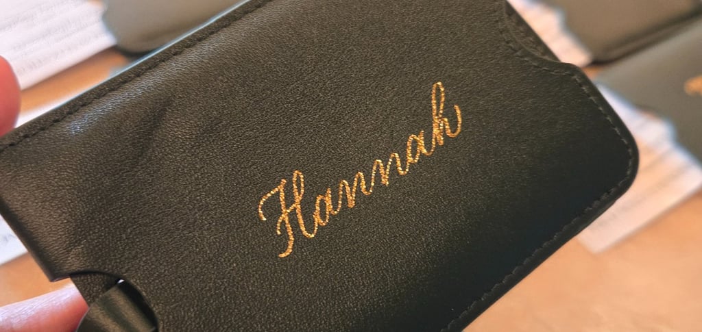 Hot foiling modern script on luggage tag by Handwritten by Belle at NYC corporate event.
