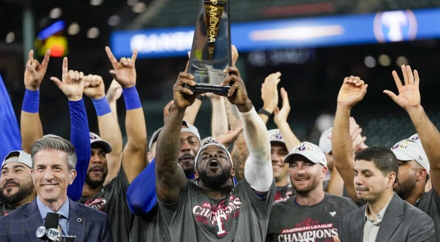 Adolis Garcia holding a trophy in front of a crowd