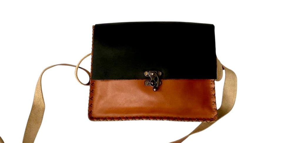 a small leather bag with a black and brown leather bag