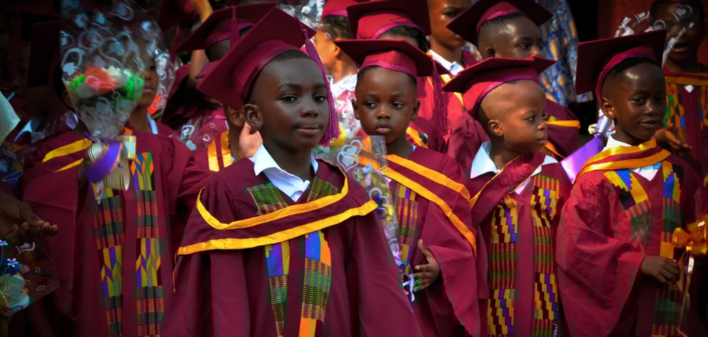 a group of young children in graduation gowns