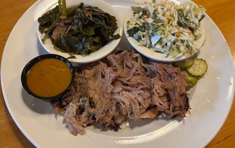 Carolina Pork Plate with Mustard Base BBQ sauce. Collard greens and cole slaw served on the side.