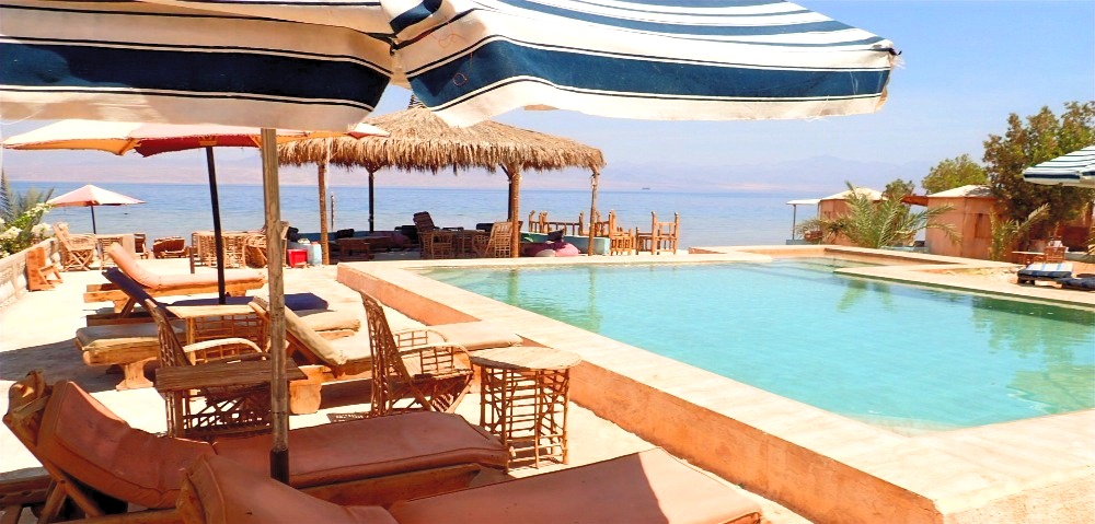 Bedouin star ras shitan lounging under the umbrella