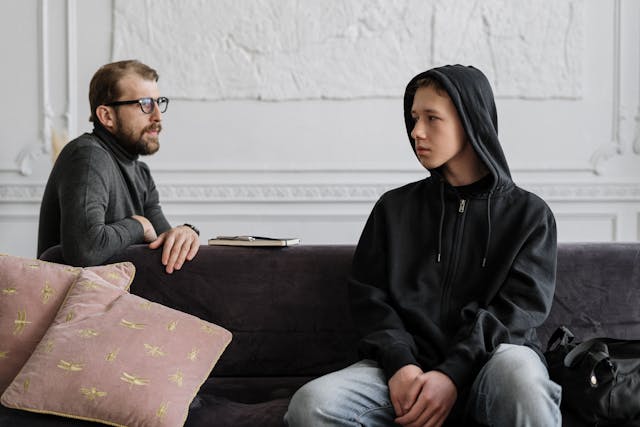 Photo by cottonbro studio: https://www.pexels.com/photo/man-in-black-hoodie-sitting-on-brown-wooden-