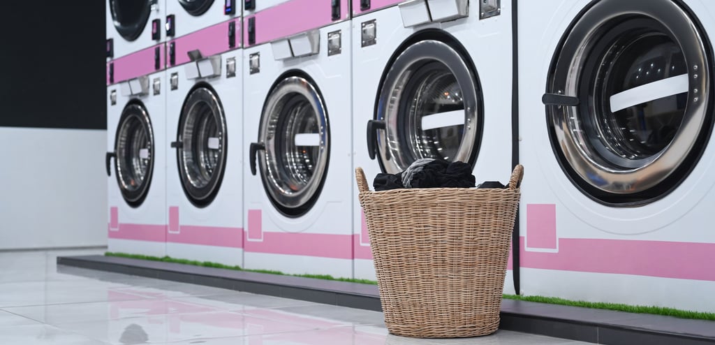 Commercial washing machines with a basket placed on top, showcasing industrial laundry equipment for heavy-duty use 1