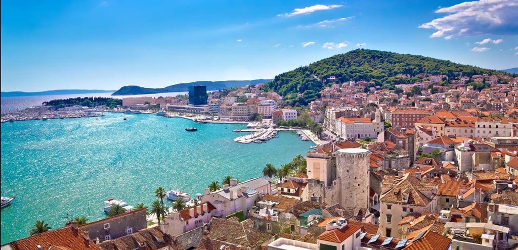 Panoramic view of Split, Croatia with red rooftops, the Adriatic Sea and Marjan Hill in the backgrou