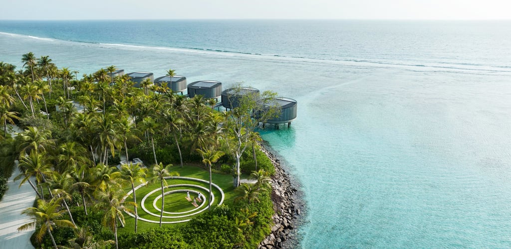 a circular shaped object in the middle of a body of water, The Ritz Carlton Maldives