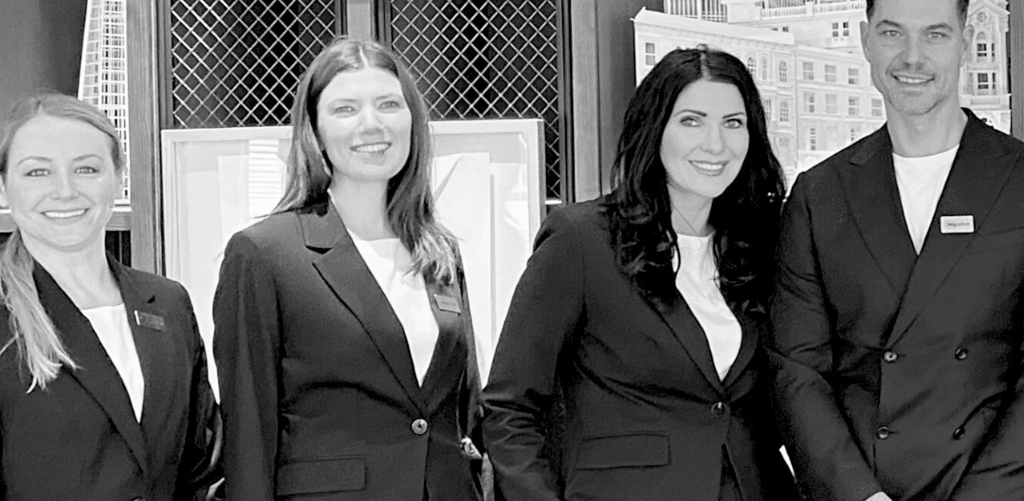 a group of business people standing in front of a building corporate hospitality events team
