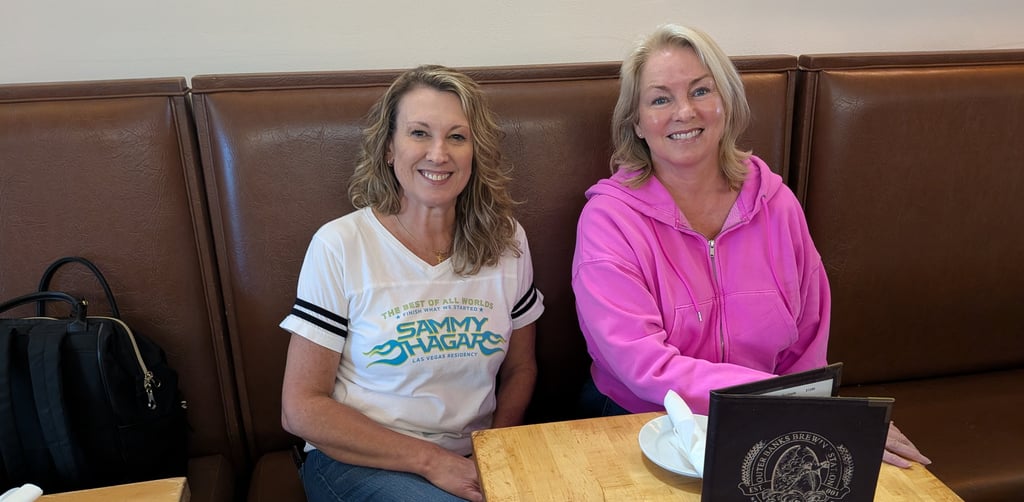 women seated in a booth at obx brewing station