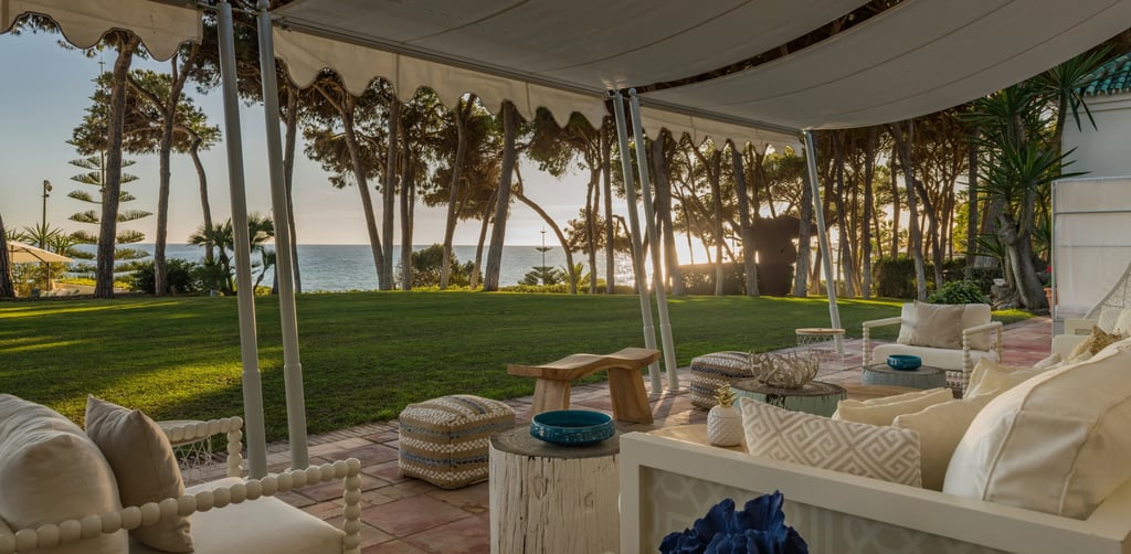 Covered beachfront terrace lounge with sunset sea views