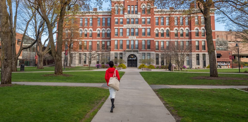 Student in red jacket on Clark University campus, showcasing pathways to academic excellence