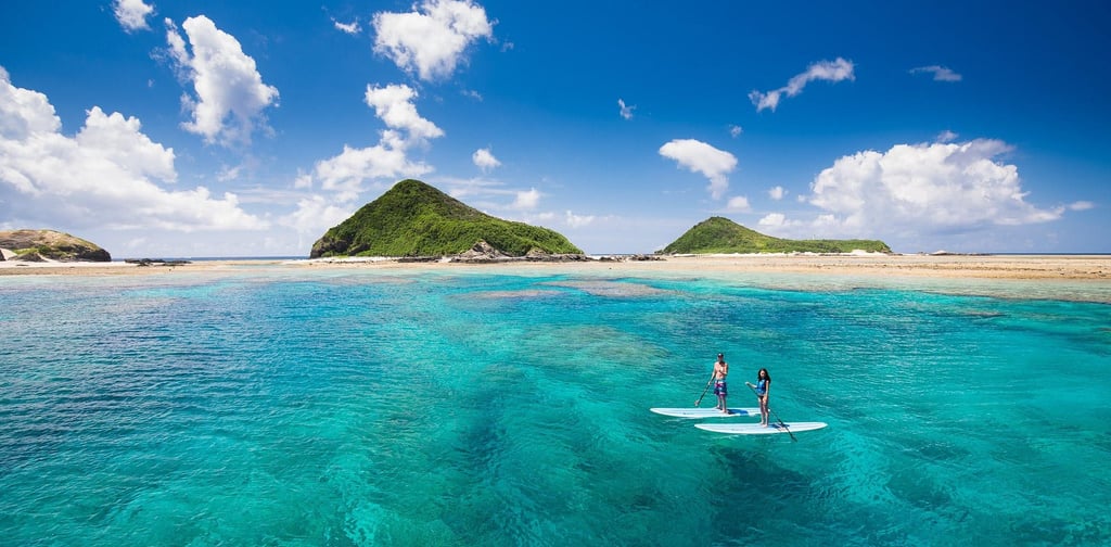 surfing in okinawa- picture of a couple surfing outside of okinawa island
