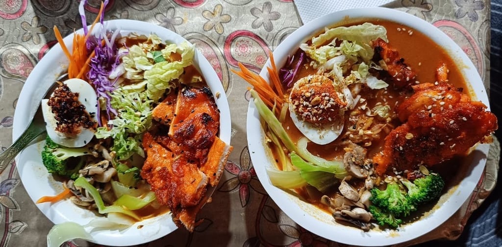 Street-style ramen bowl with creamy chicken and a spicy miso broth, offering a satisfying and flavor