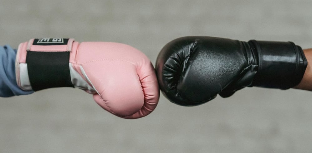 two people bumping hands in a boxing match