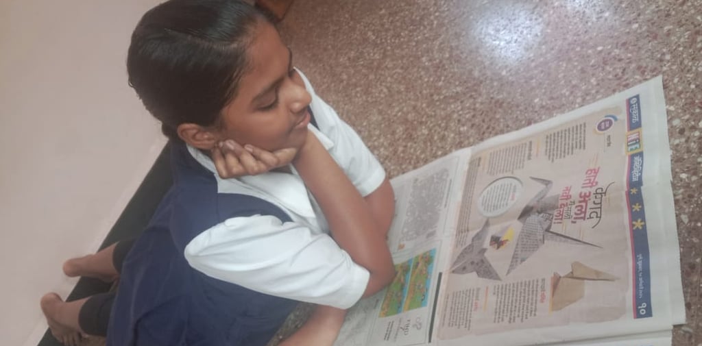 A girl student reading Origami article in Sakal NIE