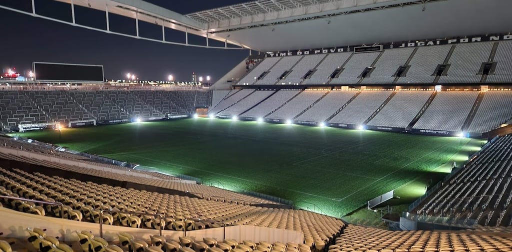 a stadium with a green field and a lot of chairs
