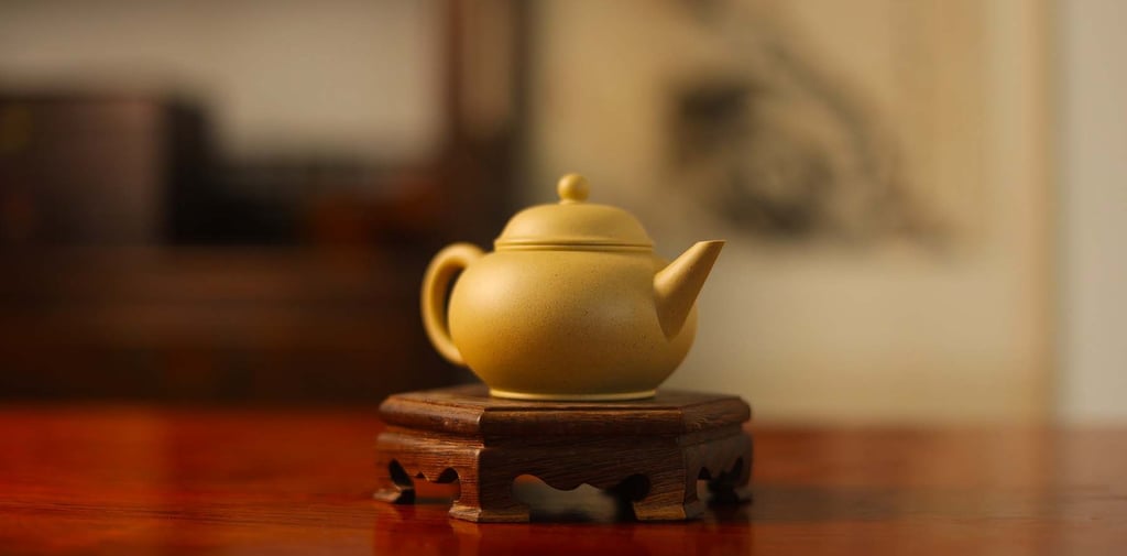 Light yellow teapot placed on a wooden stand