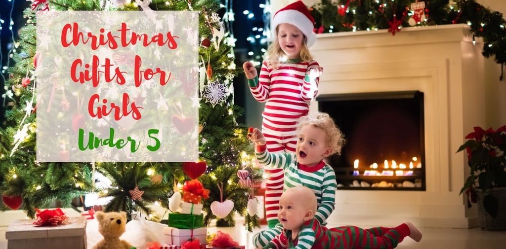 two children in pajamass with santa claus hats