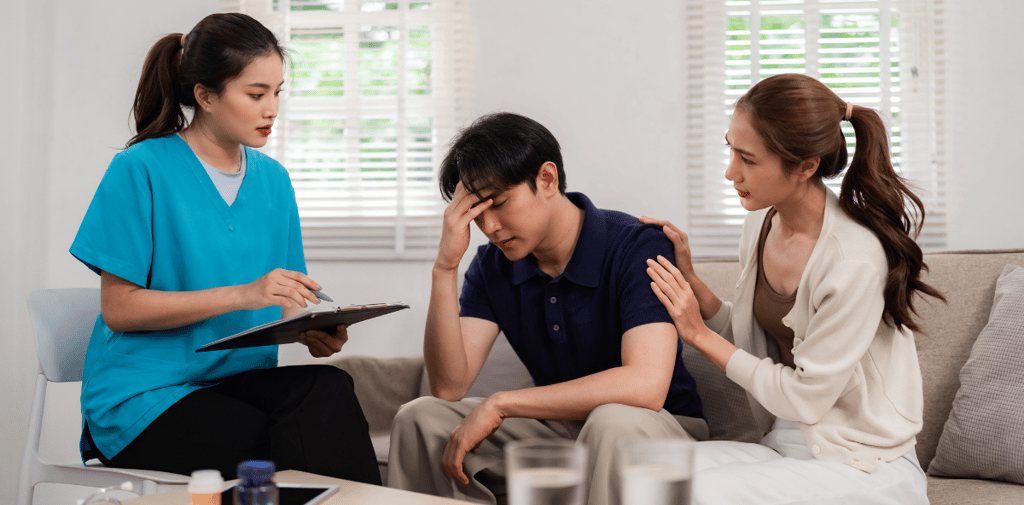 a nurse in a living room with a couple