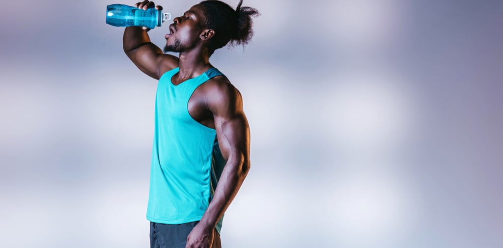 Muscular man drinking shilajit