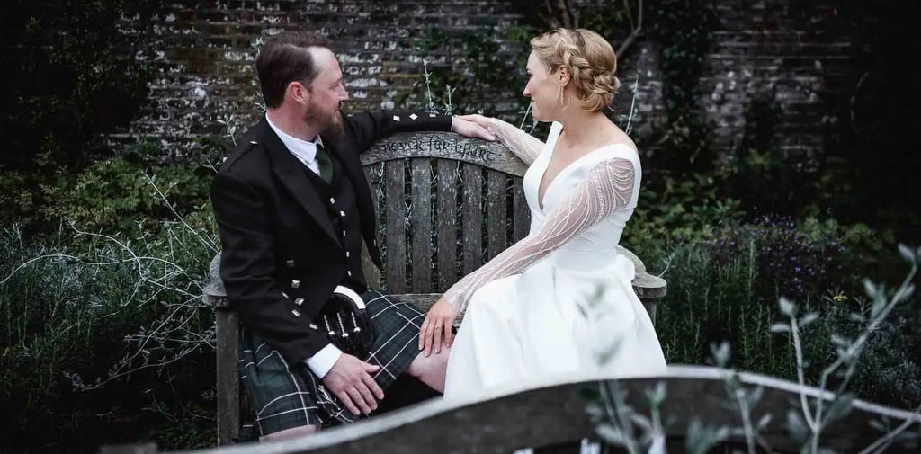 newly-weds sitting on a park bench