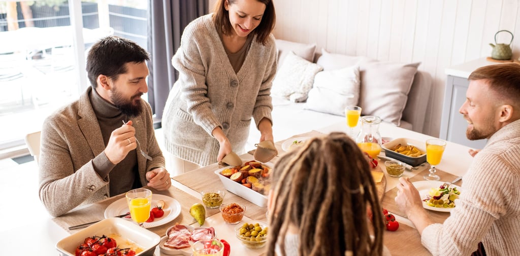 A happy family enjoys a healthy home-cooked lunch featuring roasted vegetables and fresh ingredients.
