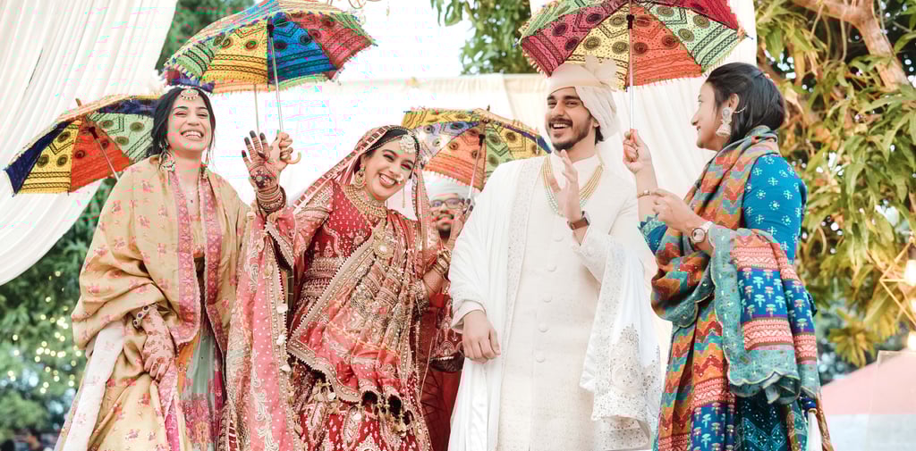 a bride and groomsmid are standing in front of a white tent