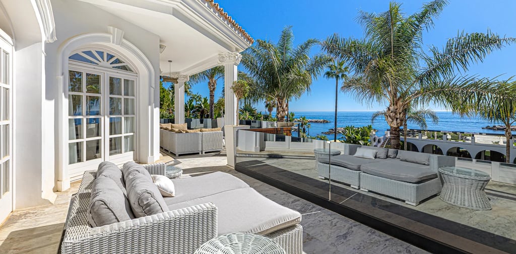 Covered terrace with seating in upscale villa by the sea Marbella