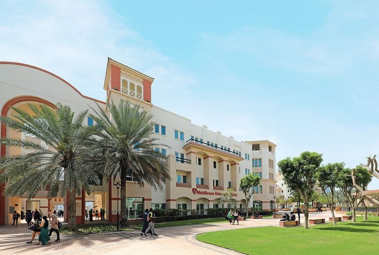 Middlesex University Dubai campus featuring a large multi-story building with a distinctive tower 