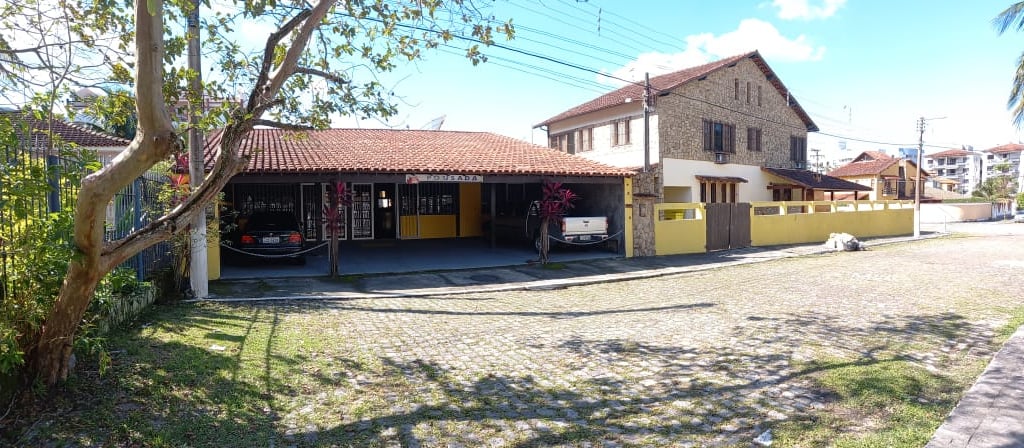 a house with a garage door and a car parked in front of it