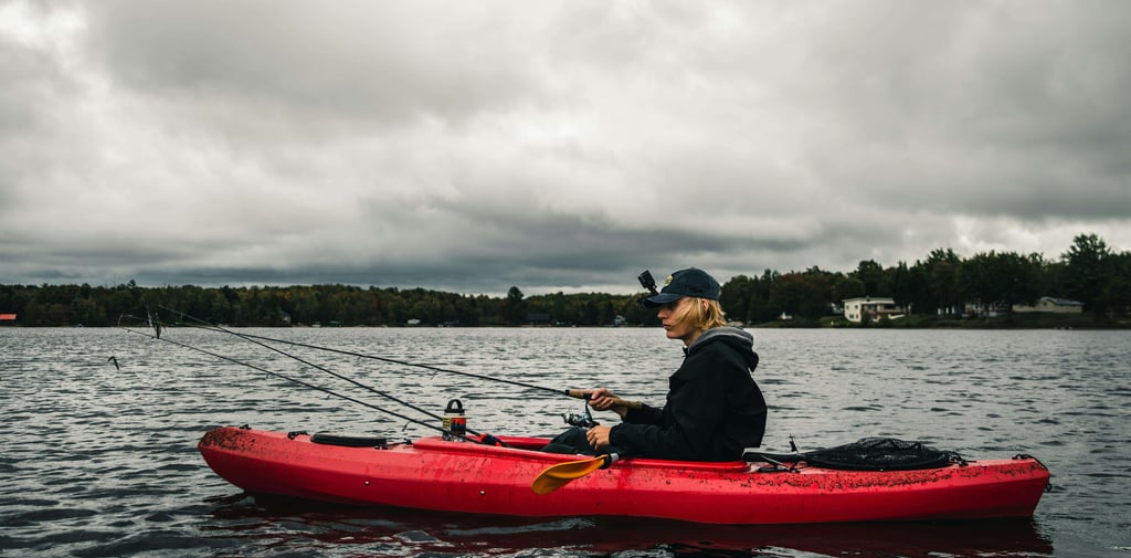 man fishing from a kayak on open water