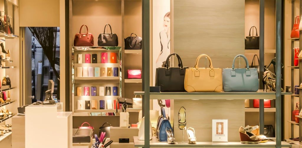a women's fashion store with handbags and shoes on display