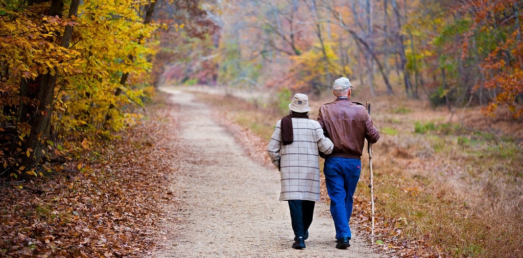 man and woman walking on fall day
