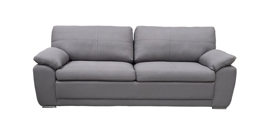 a grey couch with pillows and pillows on it