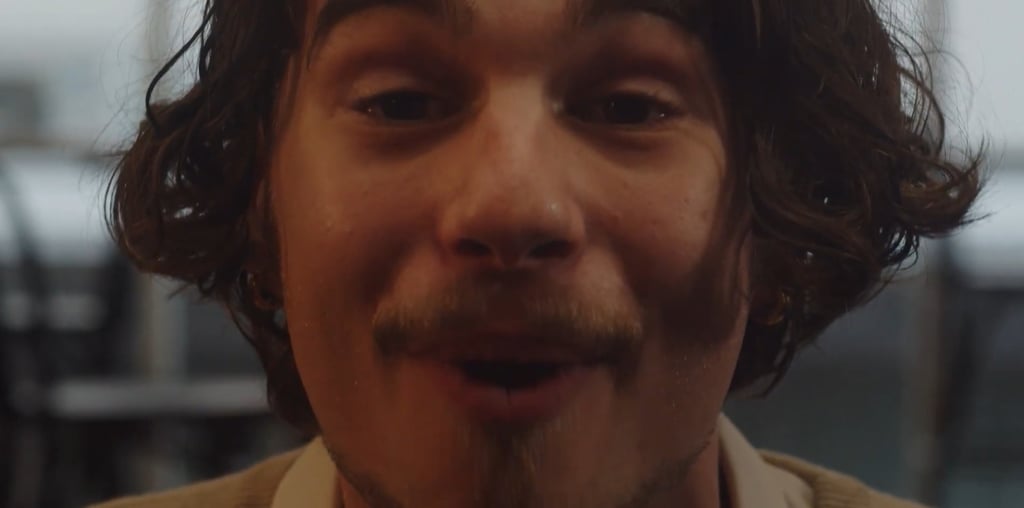 a man with a mustache and a tie on his neck