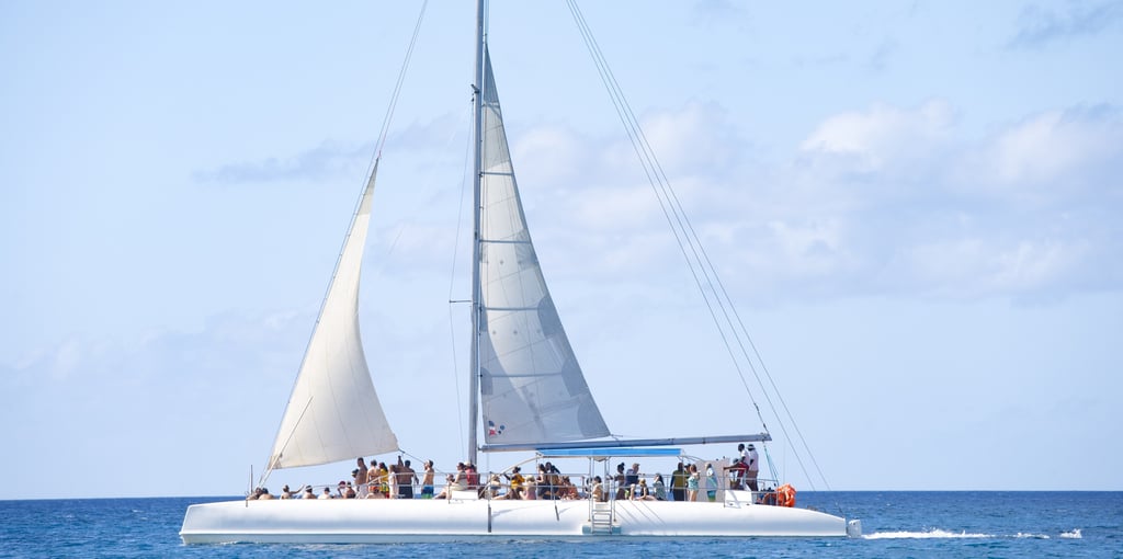 a sailboat with people on it in the ocean