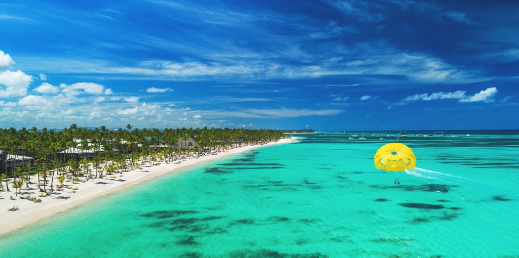 Aerial view over beach resort and ocean with Parasailing