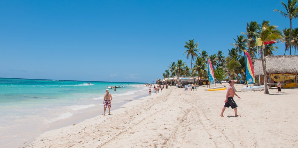 Punta Cana Bávaro Beach with white sand, turquoise water, palm trees, and beach activities