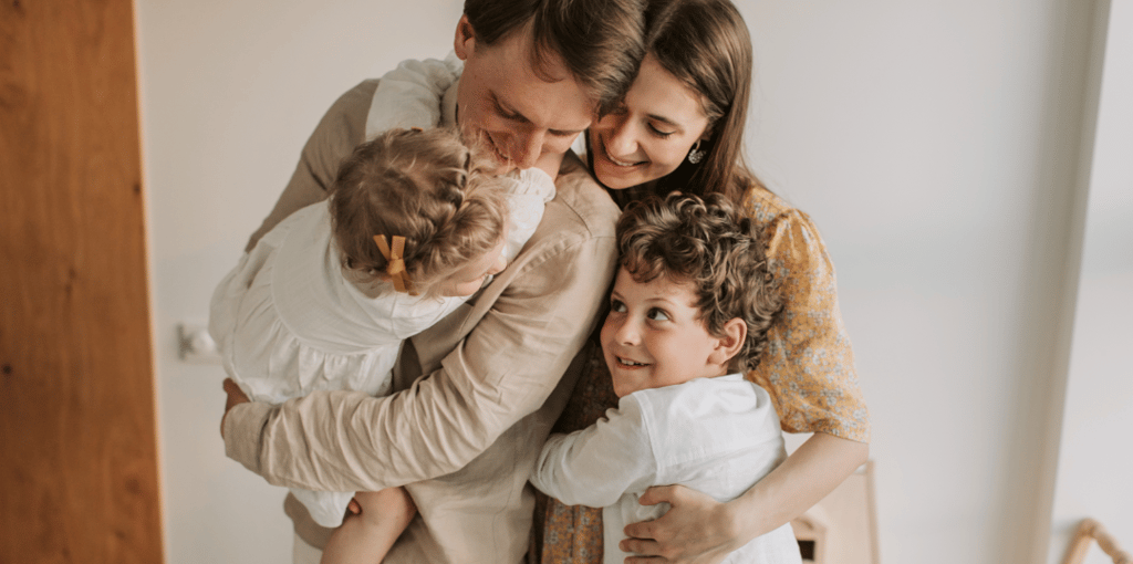 a man and two children are holding their hands while they are holding a baby
