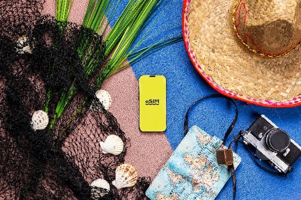 Traveler using eSIM data on smartphone to navigate foreign city