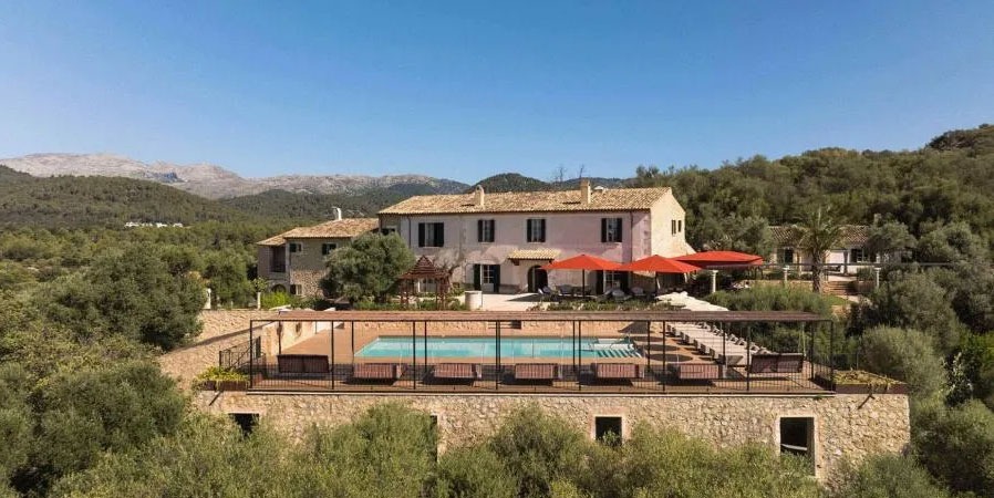 Swimming Pool with Sun Loungers and Red Parasols at Son Sabater by Zafiro