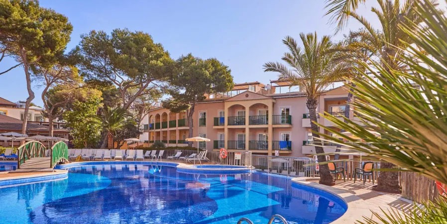 Swimming Pool Surrounded by Trees at Zafiro Cala Mesquida