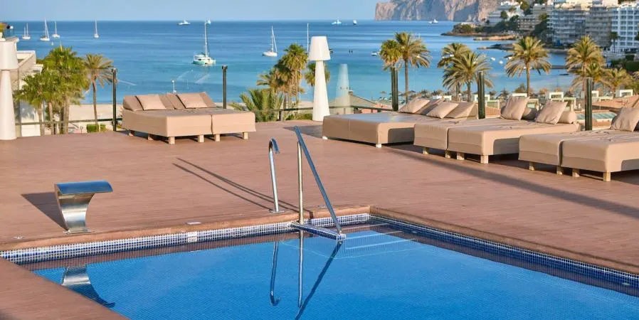Rooftop Swimming Pool, Sun Loungers and Palm Trees Overlooking the Coast at Zafiro Rey Don Jaime