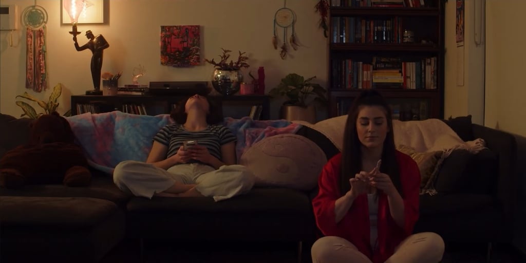 a woman sitting on a couch with a man and a woman