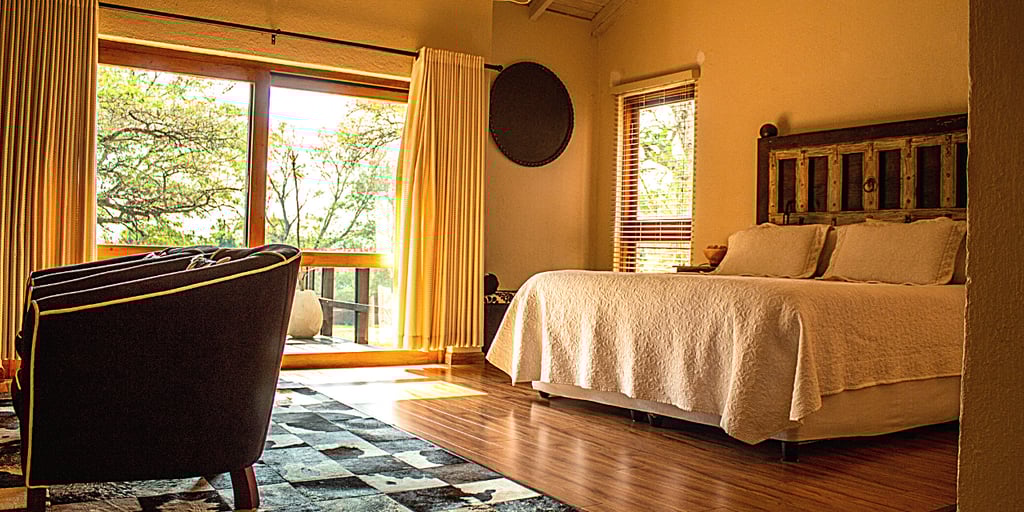 a bedroom with a bed and a chair