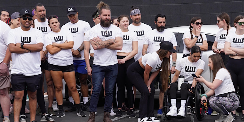 Group of individuals wearing white Winter Warrior t-shirts