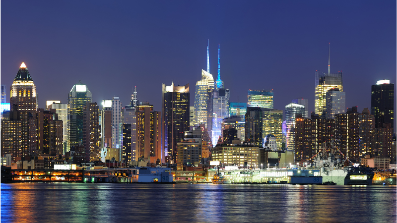 a city skyline with a boat in the water