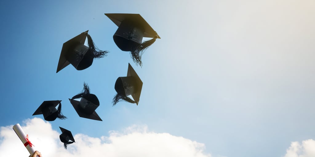 Graduates-hands-throwing-graduation-hats