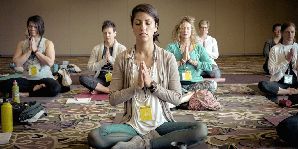 a woman in a yoga pose with her hands clasped together